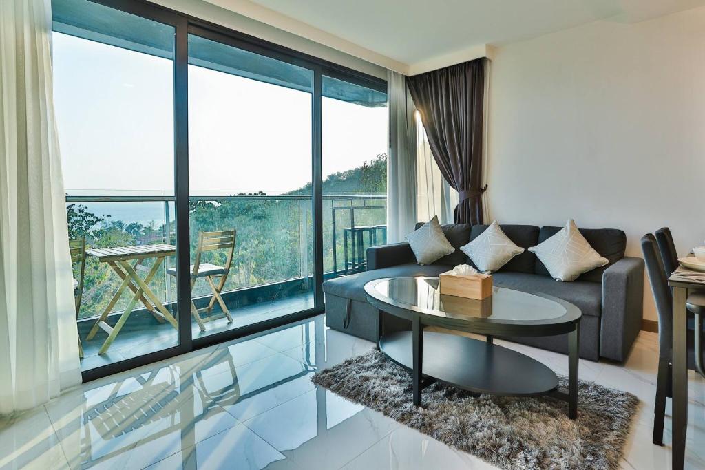 a living room with a couch and a table at A503-Penthouse Amazing View 2brs3bedsAo Nang Beach Center in Ao Nang Beach