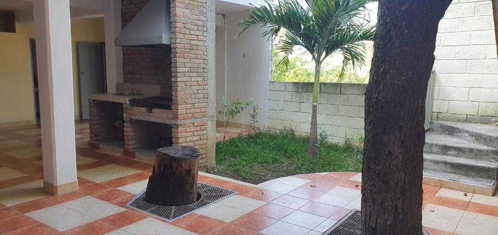 une maison dotée d'un stuc dans les arbres au milieu d'une cour dans l'établissement Departamento Escudero, à Tamazunchale