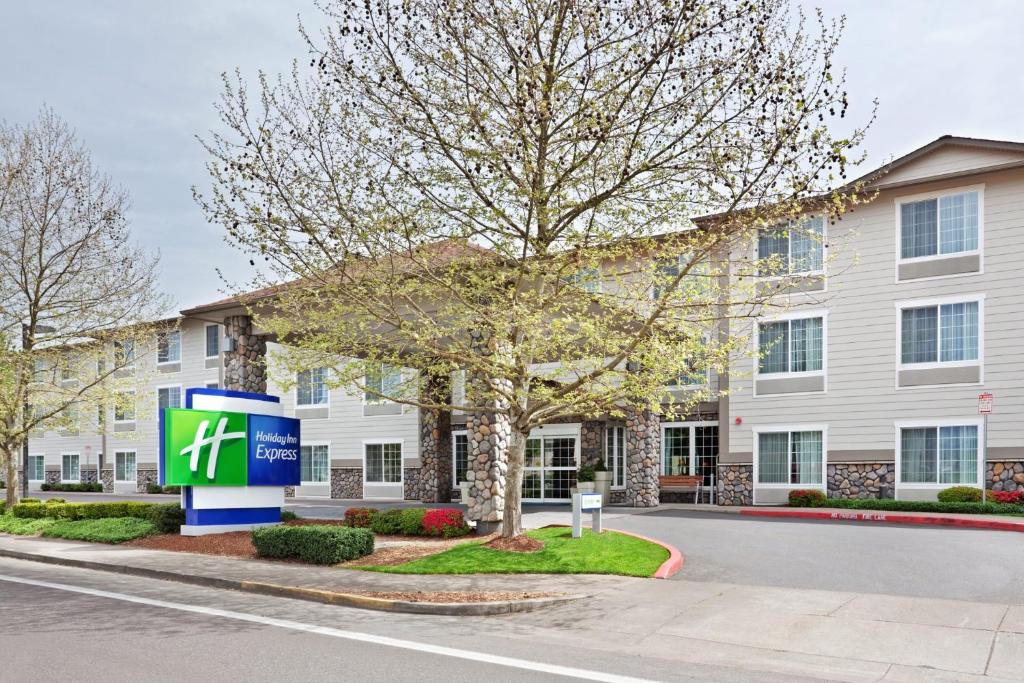 a building with a sign in front of a building at Holiday Inn Express Corvallis-On the River, an IHG Hotel in Corvallis