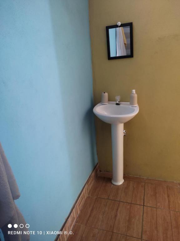 a bathroom with a white sink and a mirror at IsmaRoom in El Remate