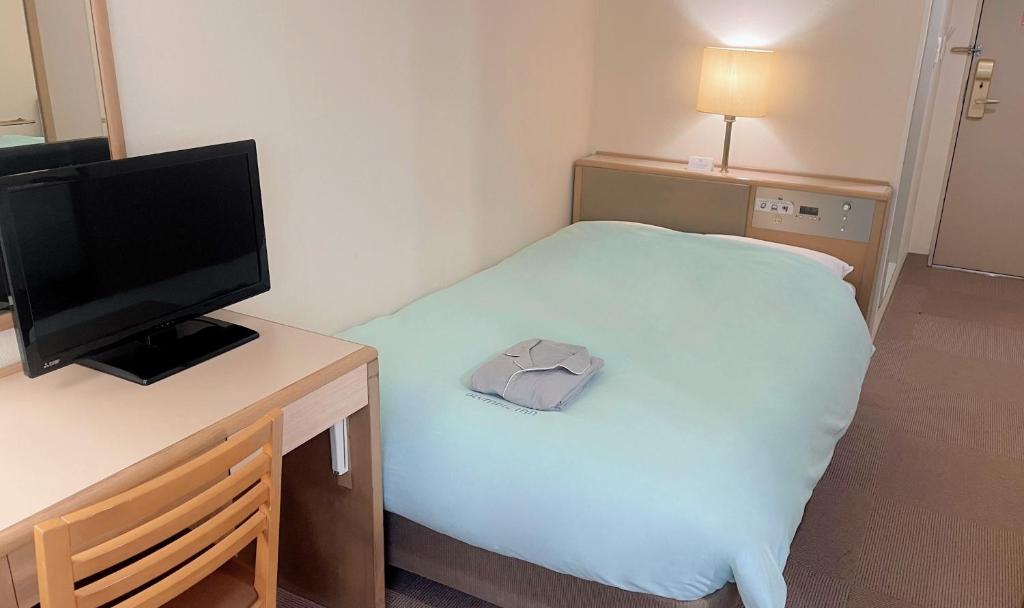 Postel nebo postele na pokoji v ubytování Olympic Inn Kanda
