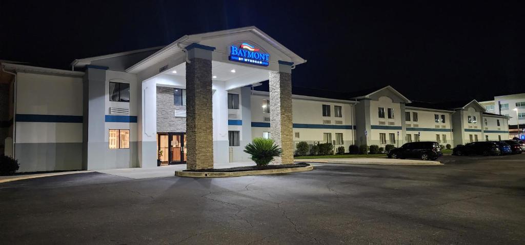 a hotel with a sign in a parking lot at Baymont by Wyndham Port Wentworth in Port Wentworth