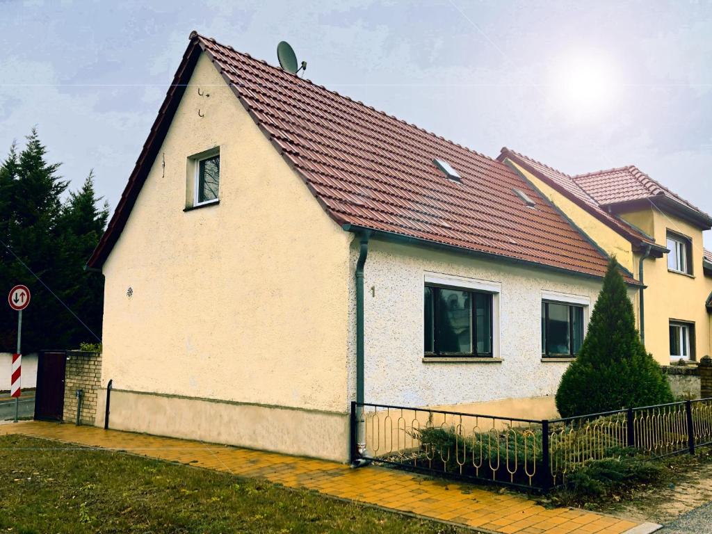a white house with a red roof at Ruhige Monteurwohnung in Werder in Plötzin