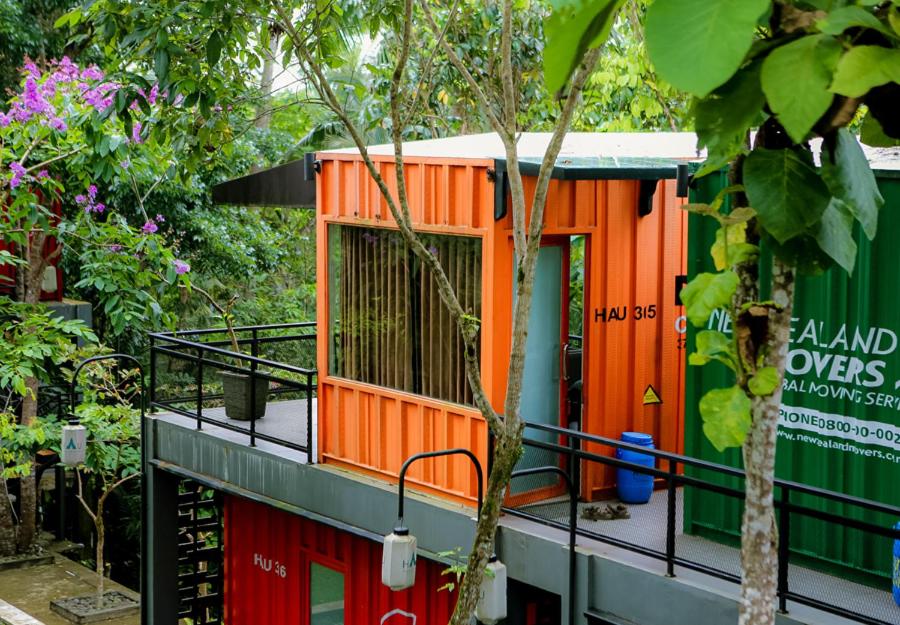 an orange tiny house on the side of a building at Hau Eco Lodges Citumang Pangandaran in Pangandaran