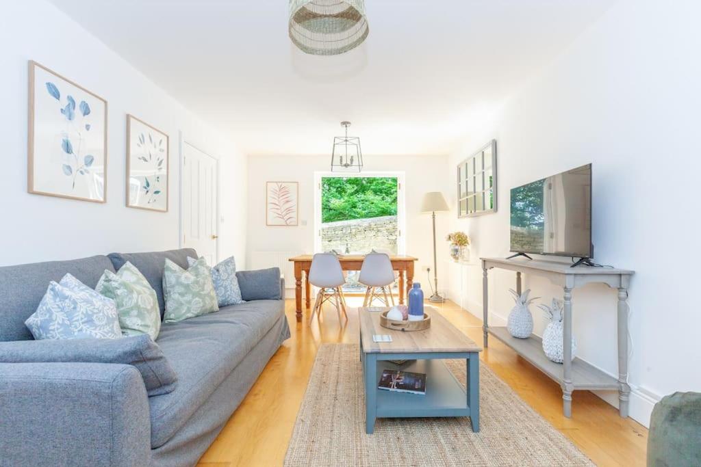 a living room with a couch and a table at Oxfordshire Living - The Henrietta Cottage - Woodstock in Woodstock