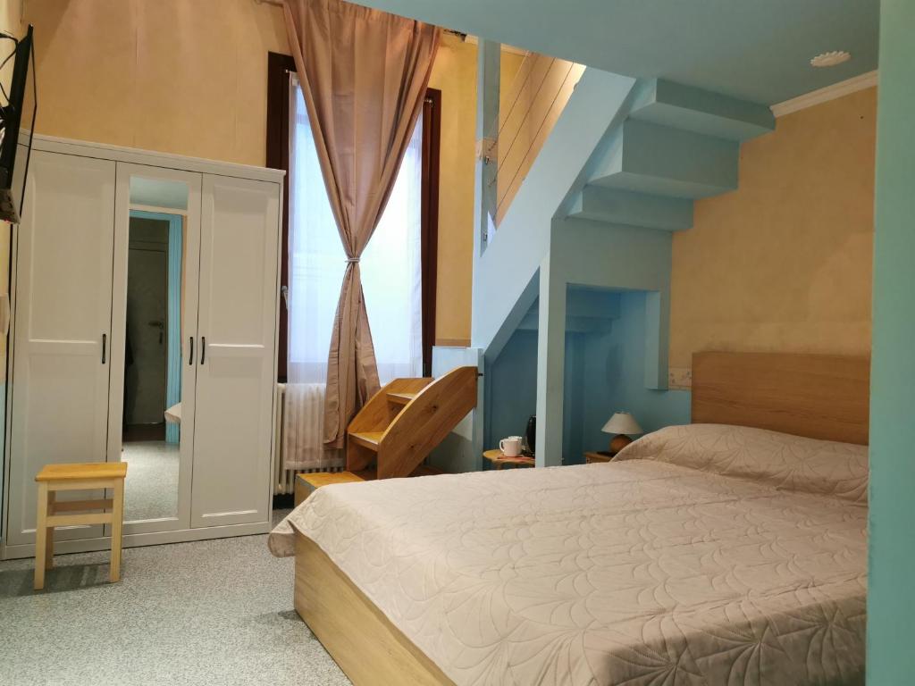 a bedroom with a large bed and a staircase at Venice Dose Suite in Venice
