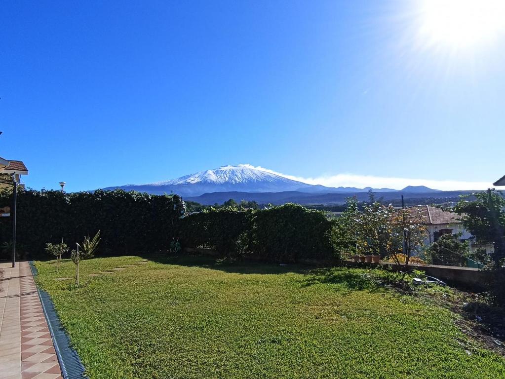 a view of a snow covered mountain in the distance at Good Morning Etna in Bronte
