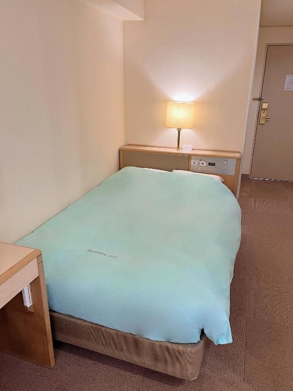 Postel nebo postele na pokoji v ubytování Olympic Inn Kanda