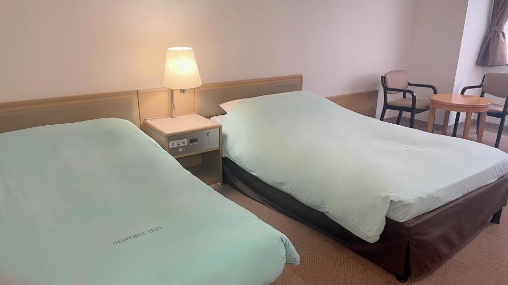 Postel nebo postele na pokoji v ubytování Olympic Inn Kanda