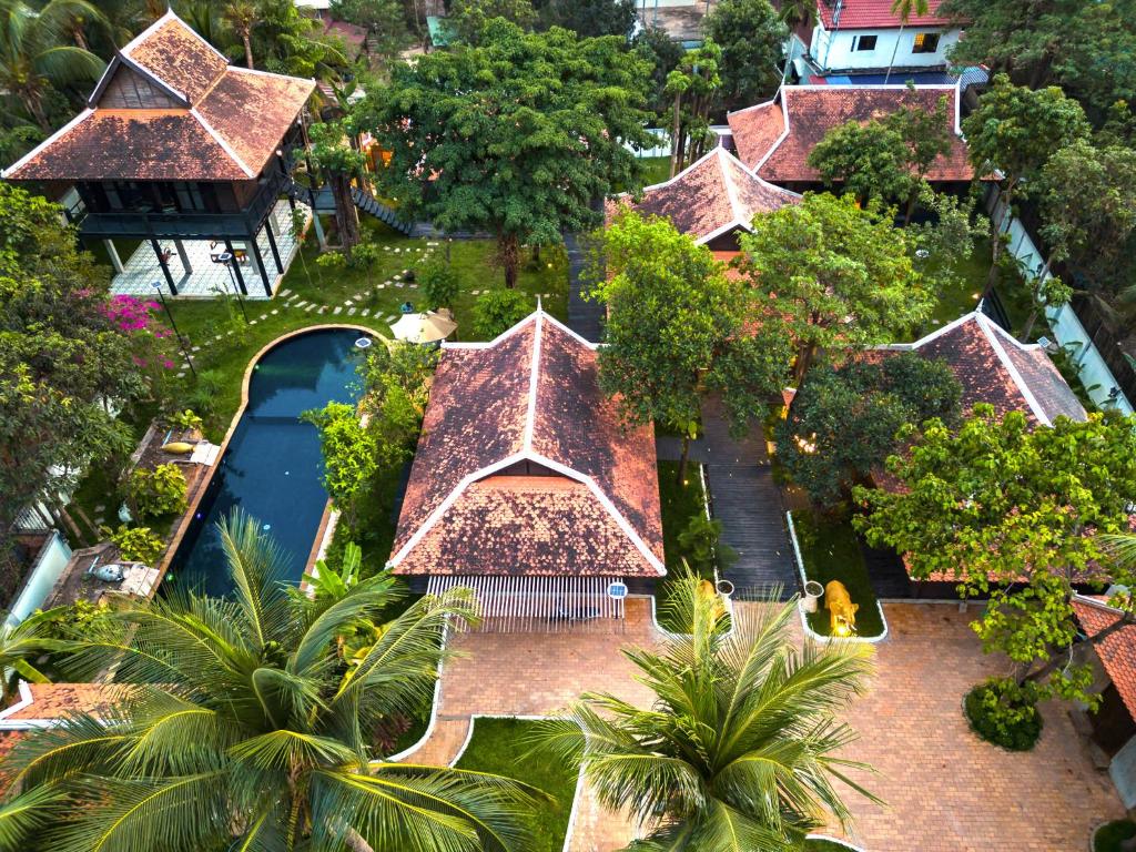 an aerial view of a resort with a pool and trees at SOK VILLA by Angkorstays in Siem Reap
