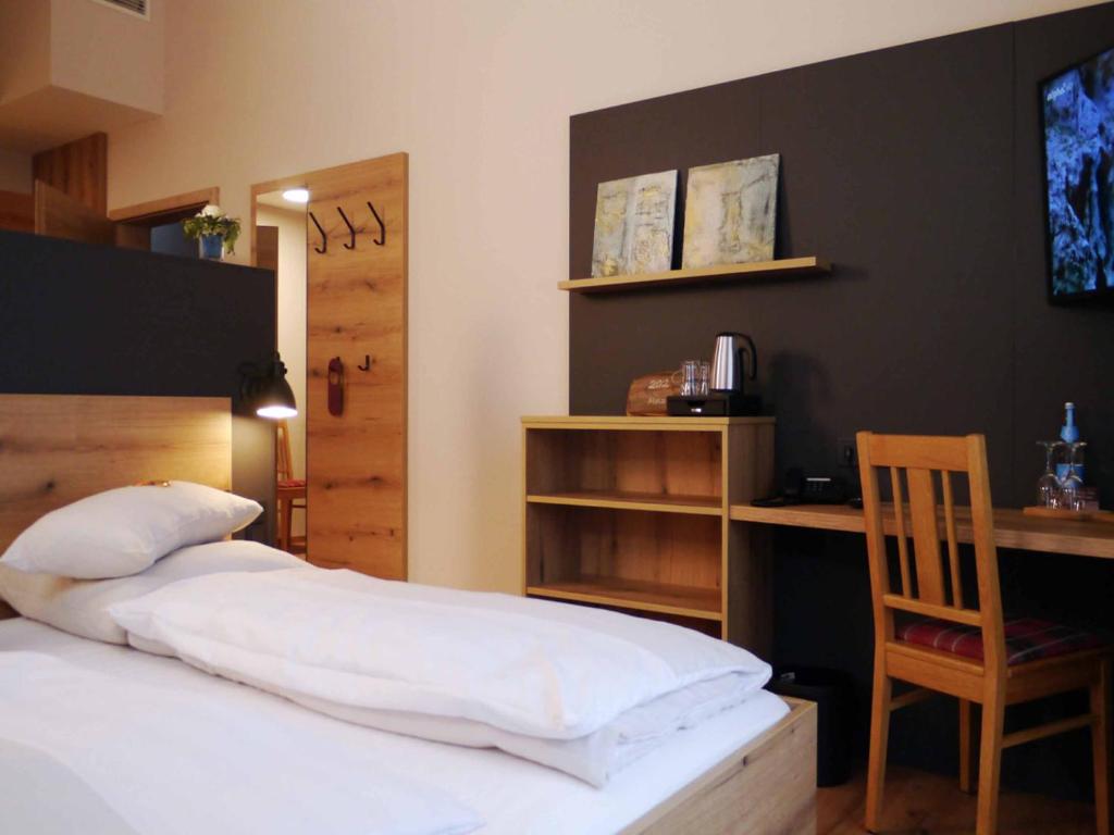 Postel nebo postele na pokoji v ubytování Da`Sporrer Hotel & Wirtshaus