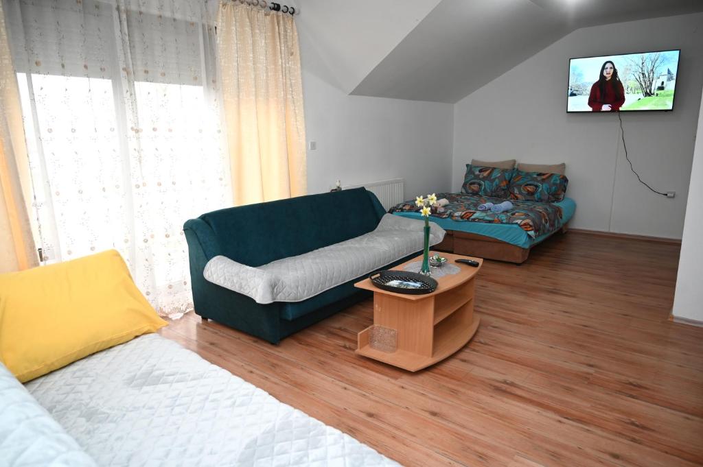 a living room with a couch and a table at Apartman Sena in Laktaši