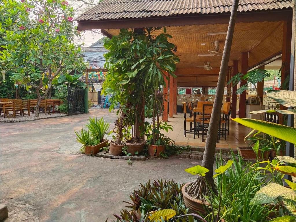 a patio with a bunch of trees and plants at The Shire Guesthouse in Chiang Mai
