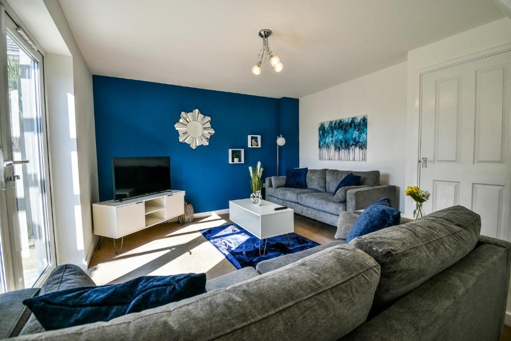 uma sala de estar com um sofá e uma televisão em Einstein House Horizon Stays em Stockton-on-Tees