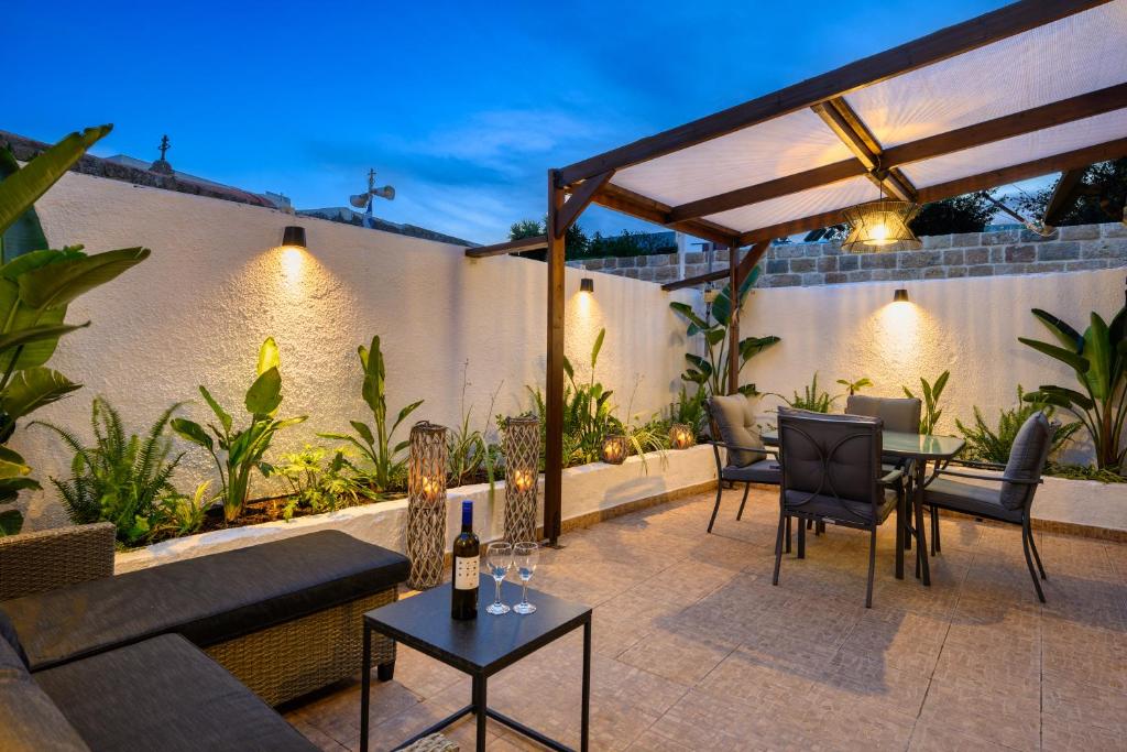 a patio with a couch and chairs and a table at Old Town Villa in Rhodes Town