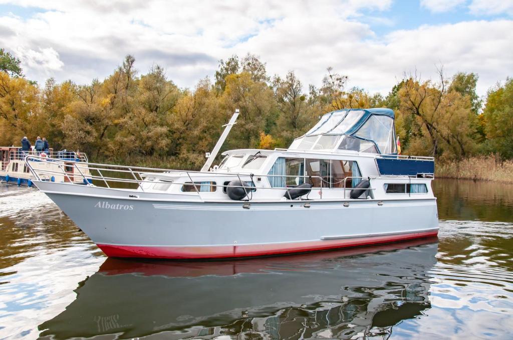 a white boat in the water on a river at Motoryacht Albatros Proficiat 1120 GL in Buchholz