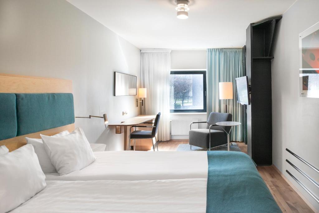 Postel nebo postele na pokoji v ubytování Quality Hotel 11 & Eriksbergshallen