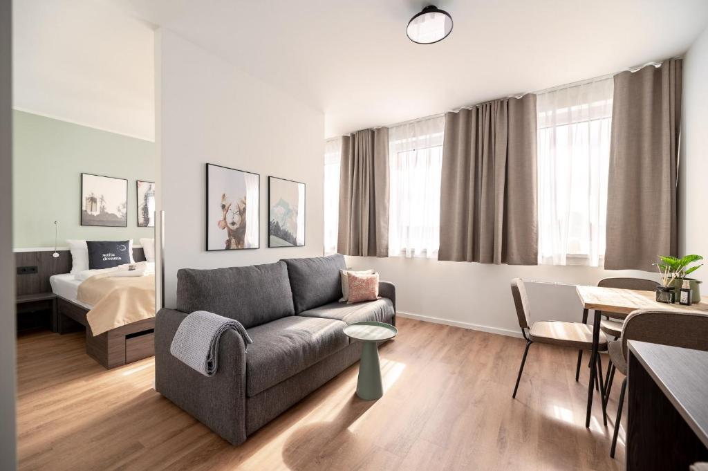 a living room with a couch and a bedroom at Limehome Bremerhaven Kantstraße in Bremerhaven