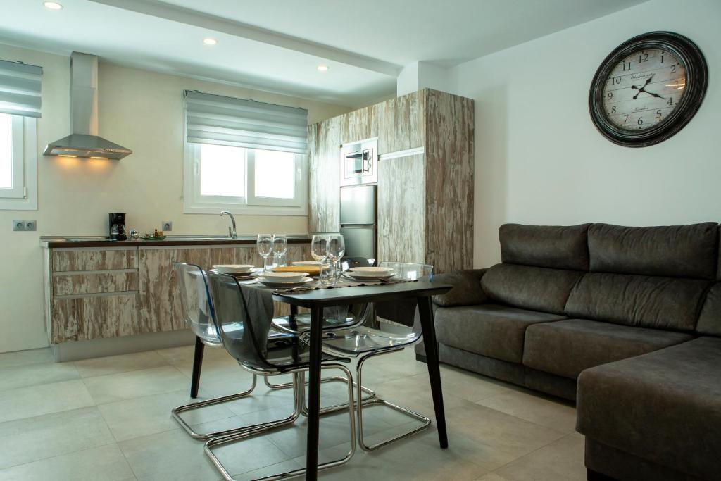 a living room with a table and a couch at Apartamentos Aponiente in Conil de la Frontera