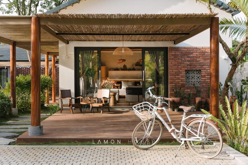 a bike is parked on a wooden deck at LaMon House - Venuestay in Hòa Bình