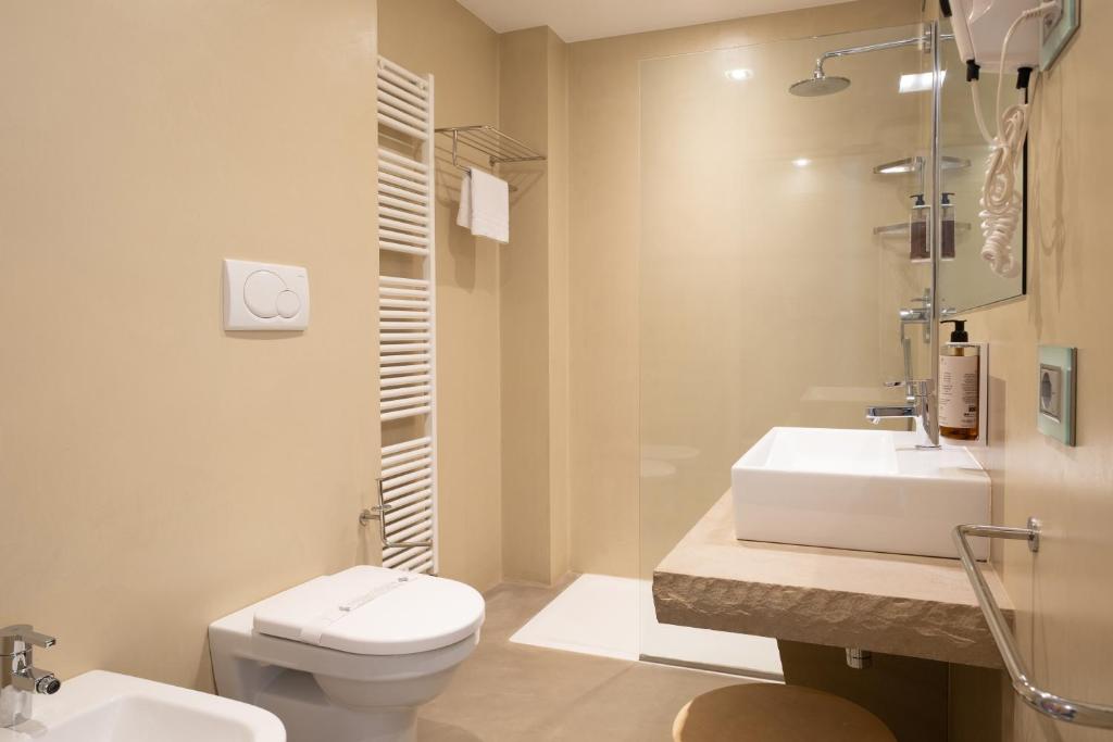 a bathroom with a toilet and a sink at The Ziba Hotel & Spa in Peschiera del Garda