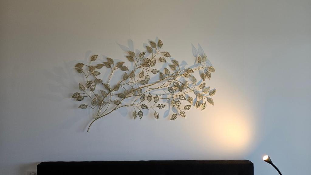 a painting of a plant on a white wall at Arbre Blanc, une folie montpelliéraine in Montpellier