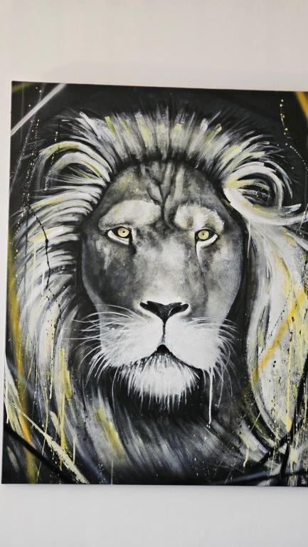 a painting of a lion with yellow eyes at Arbre Blanc, une folie montpelliéraine in Montpellier