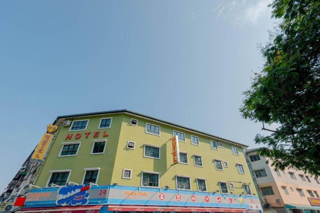 a yellow building with a hotel sign on it at GS Golden Star Hotel in Seri Kembangan
