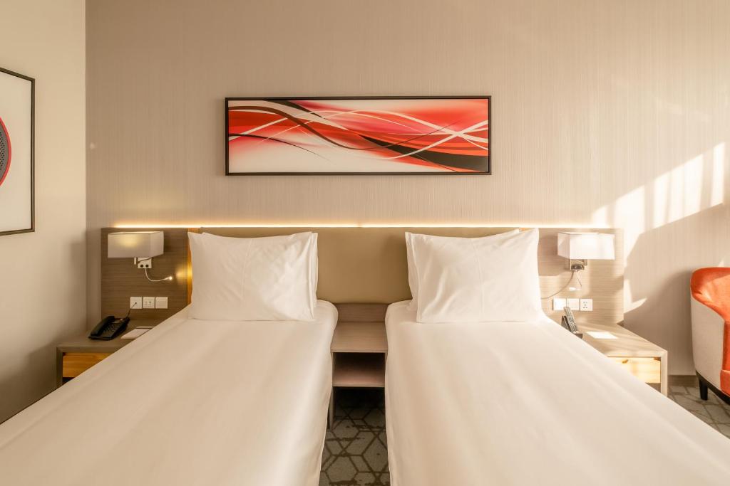 Postel nebo postele na pokoji v ubytování Peony Hotel
