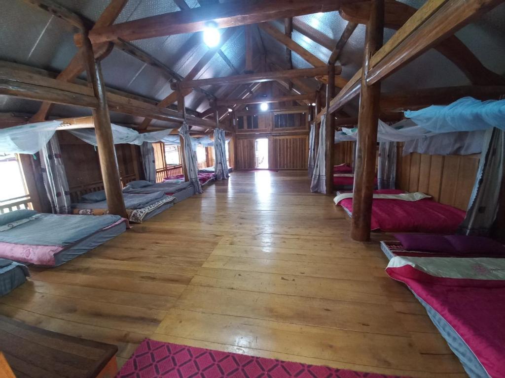 a room with a bunch of beds in it at Homestay Hoàng Vũ in Ha Giang