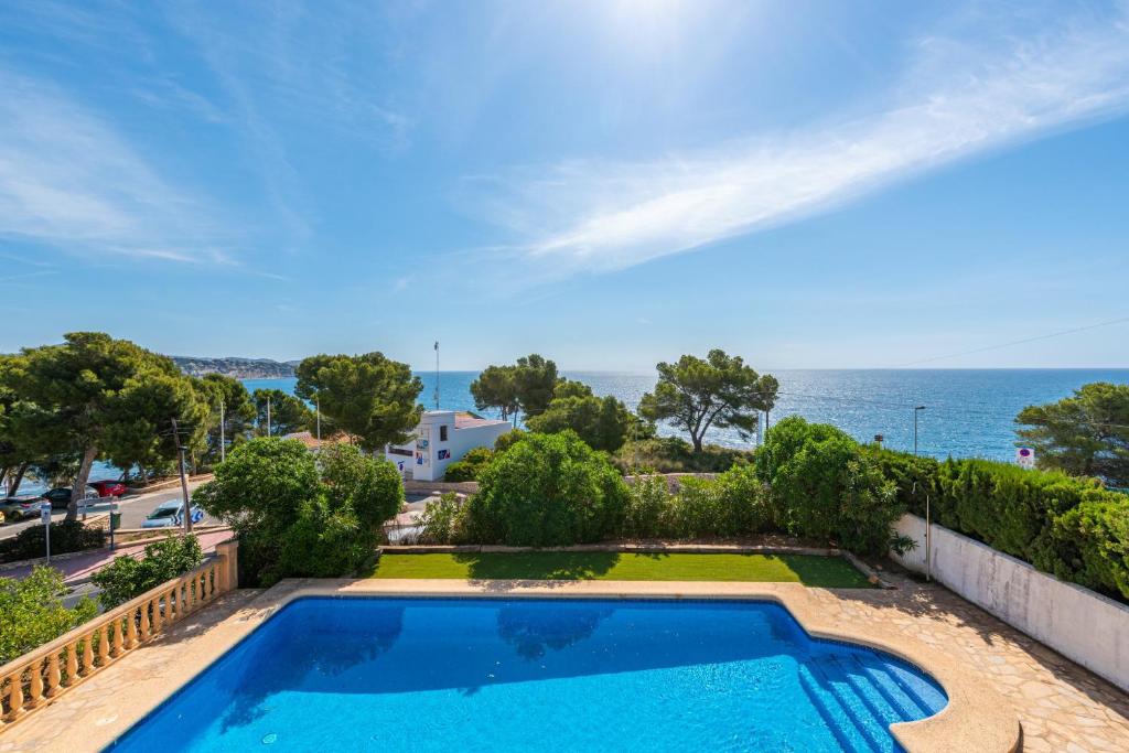 a swimming pool with a view of the ocean at Villa Diego - PlusHolidays in Benissa