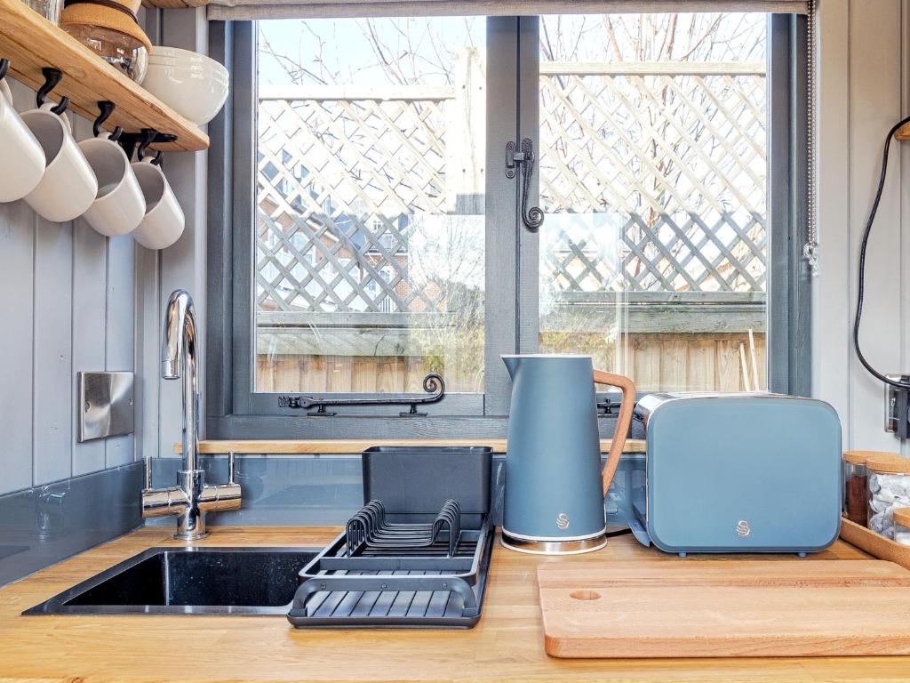 a kitchen counter with a sink and a toaster at Pass the Keys Whitstable Shepherds Hut minutes from the Harbour in Whitstable