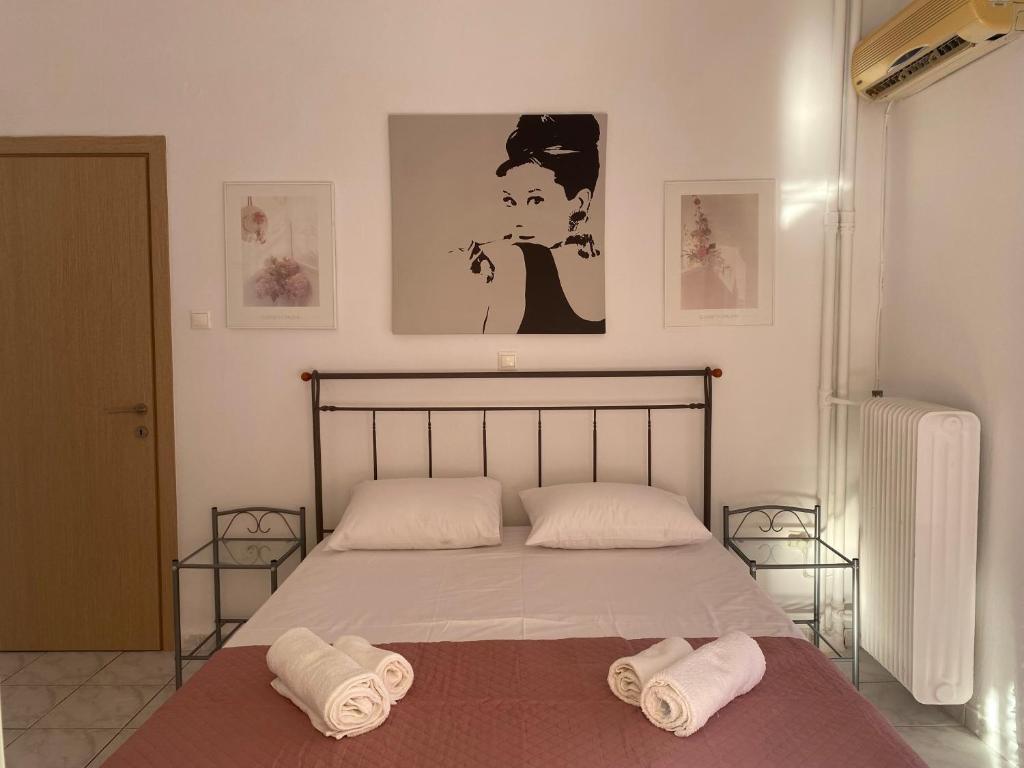 A bed or beds in a room at Aphrodite Home