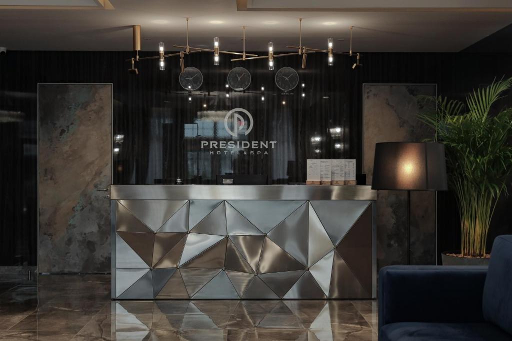 a lobby with a reception desk in a room at President Hotel&Restaurant&SPA in Trostyanets