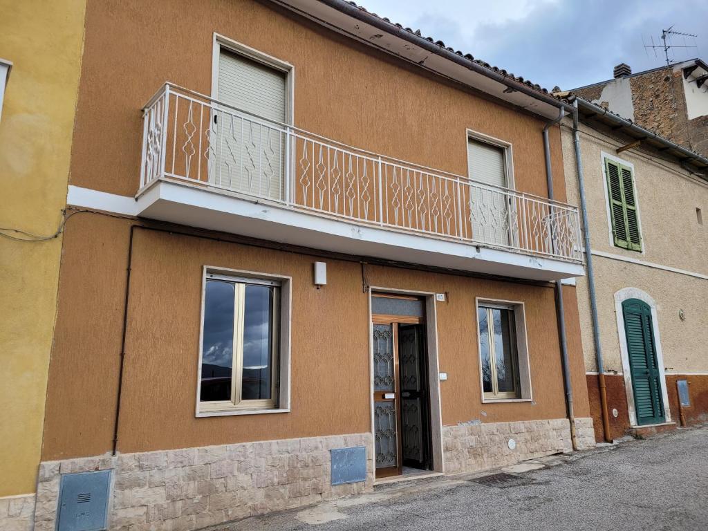 a building with a balcony on top of it at Casa Adélona in Ofena