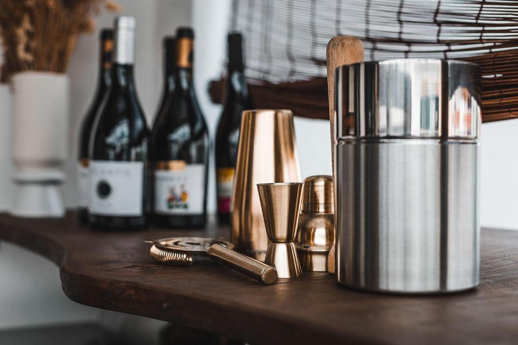 a table with bottles of wine and a juicer at Casa Idalia Boutique Hotel in Comporta