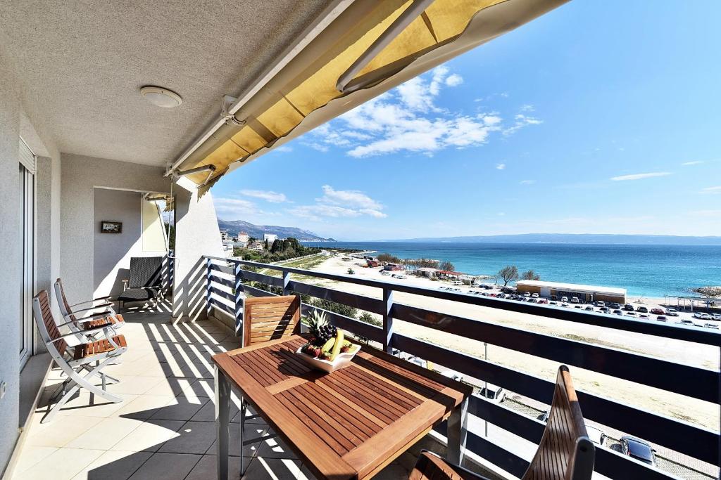 a balcony with a table and a view of the ocean at Apartment Stiv Luxe in Split