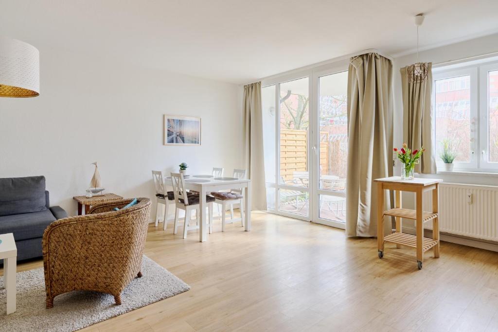 a living room with a couch and a table at Ferienwohnung Sonnendeck Moba-Travel in Priwall