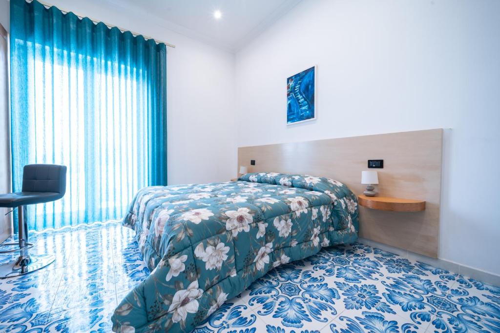 a hotel room with a bed and a window at Palazzo De Gregorio Apartment Napoli in SantʼAntonio Abate