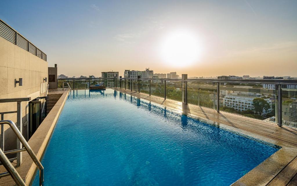 a swimming pool on the roof of a building at Luxury Apartments with Rooftop Pool & Gym - Avalon in Ho Chi Minh City