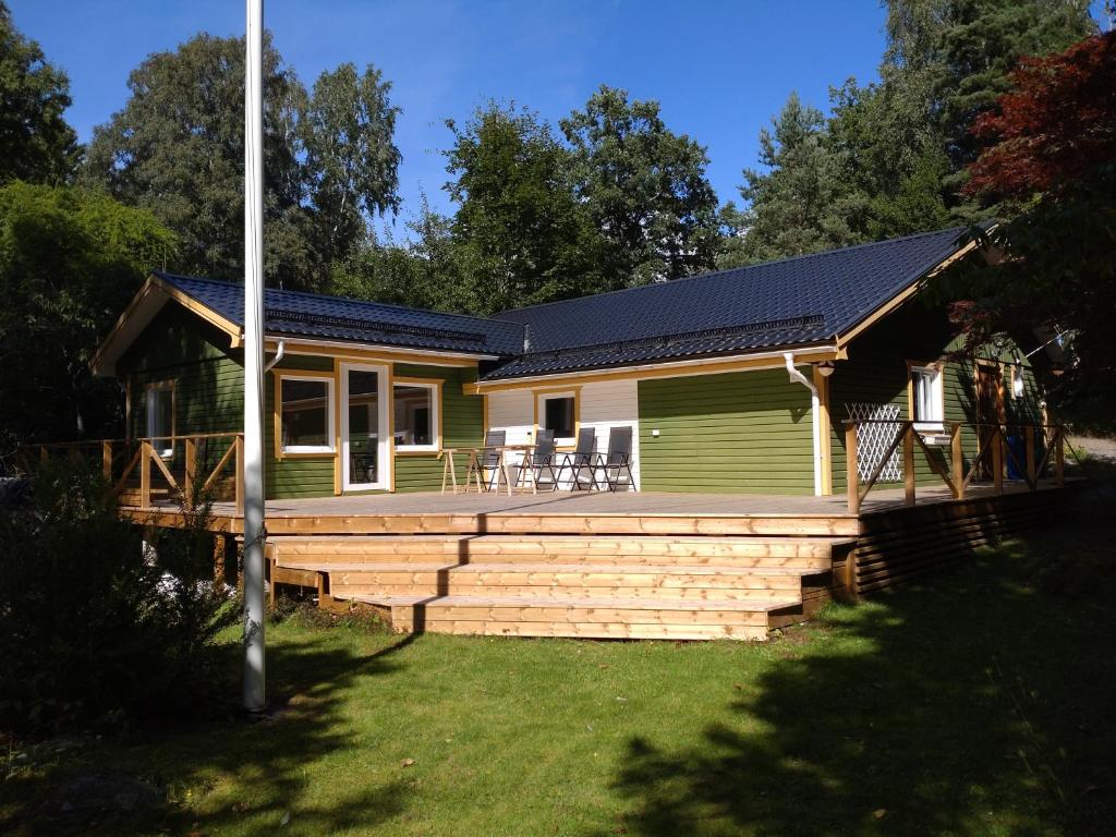 a house with a porch and a deck at Sittesta 56 in Ösmo
