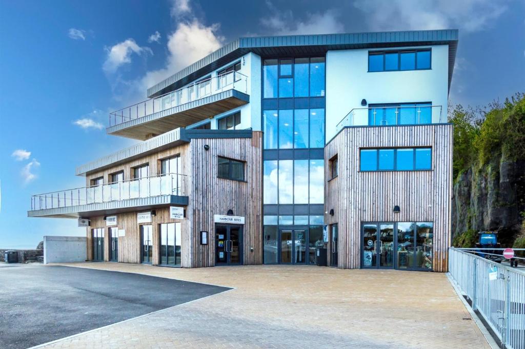 a large building with a lot of windows at No 5 Ocean Cabins - Saundersfoot Harbour - Saundersfoot in Saundersfoot