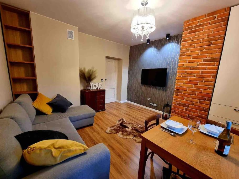 a living room with a couch and a table at Apartament Szeroka Gdańsk, Stare Miasto in Gdańsk