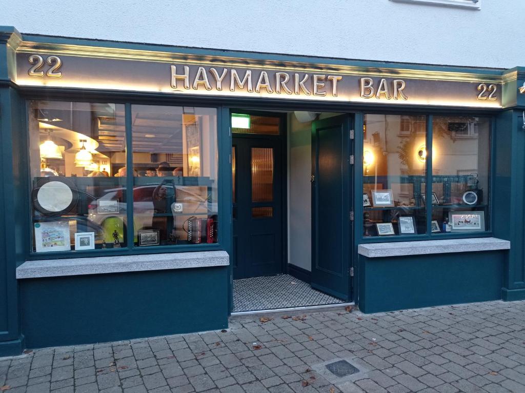 a harvard market bar with the front of the building at Moy Hotel in Mayo
