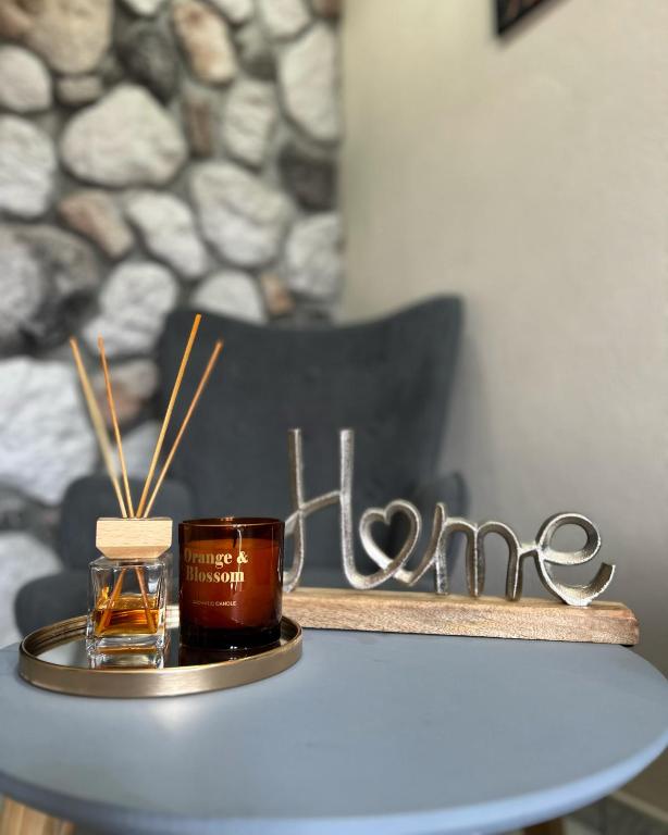 a table with a jar of honey and a candle at Catch n relax in Kalabaka