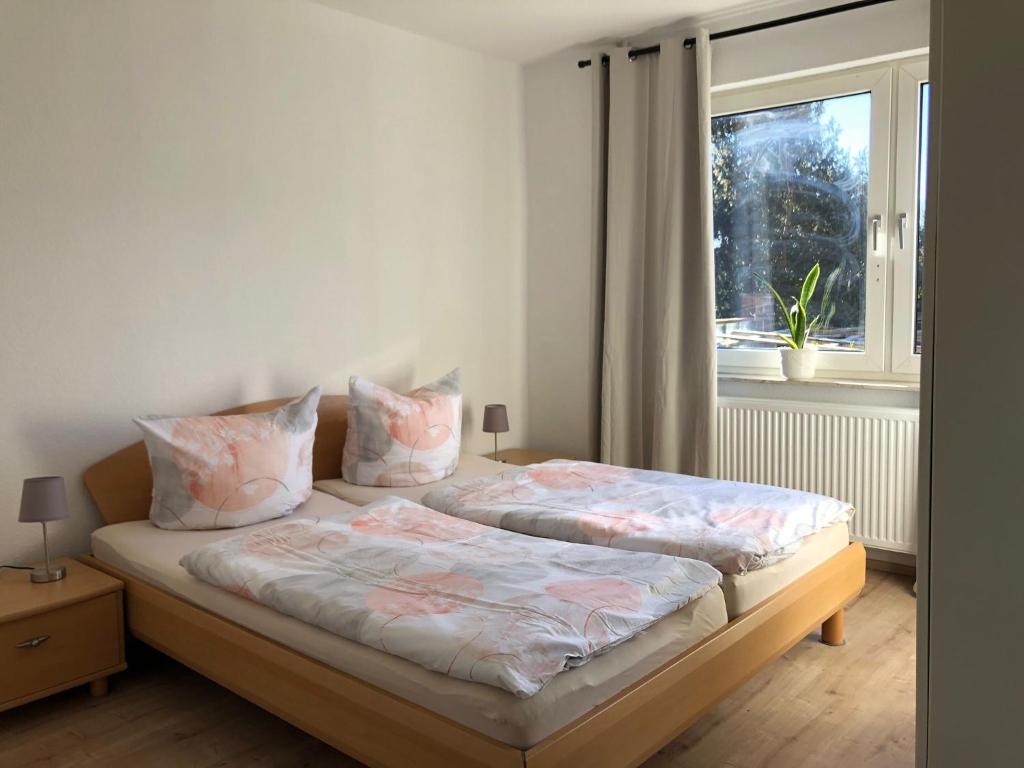 a bedroom with two beds and a window at Lotus 4 in Cuxhaven