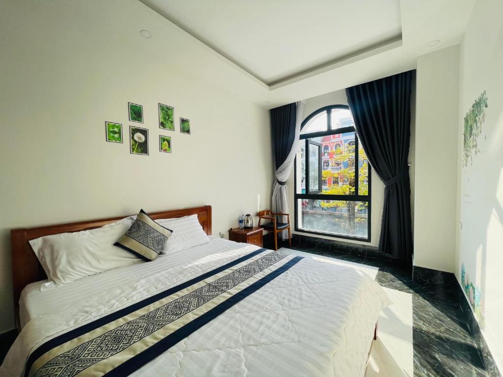 Postel nebo postele na pokoji v ubytování Coffee Pacific Grand World Phú Quốc