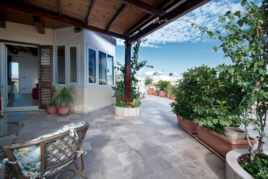 eine Terrasse mit Pflanzen und einer Bank an einem Haus in der Unterkunft SARI CASA VACANZE in Nardò