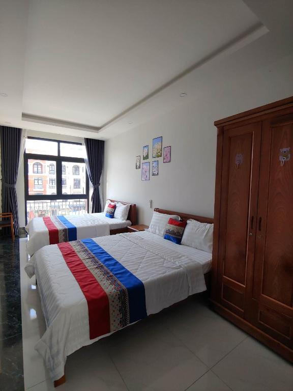 Postel nebo postele na pokoji v ubytování Coffee Pacific Grand World Phú Quốc