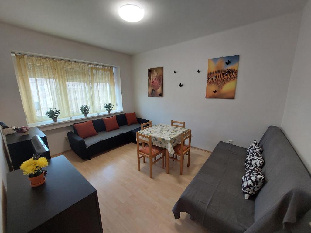 a living room with a couch and a table at Apartmán v centre Bratislavy in Bratislava